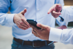 Business men pointing on a smartphone