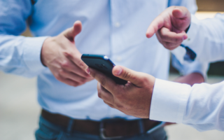 Business men pointing on a smartphone