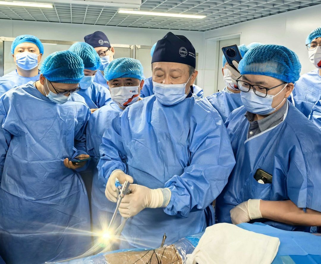 a group of asian surgeons being instructed and educated by joimax faculty member in endoscopic spine surgery