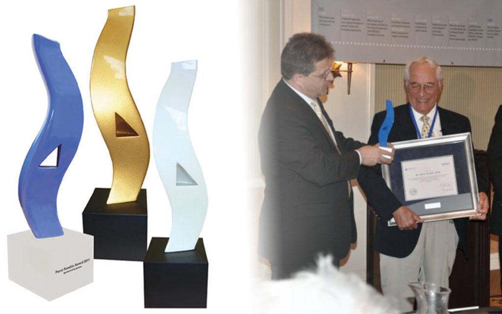 detailed shot of Blue Golden and Pearl Kambin Awards by joimax on the left and Wolfgang Ries giving the first blue Kambin Award to Parviz Kambin on the right