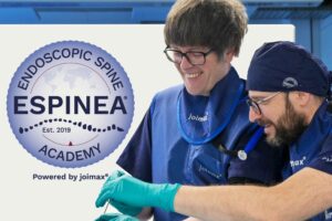 Two Surgeons in a endoscopic spine surgery education and training environment with the ESPINEA Logo in the Background